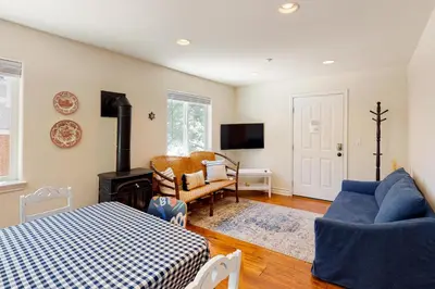 a bedroom with a bed and a living room at Bayfront Beauty in Lake Arrowhead