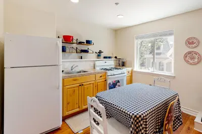 a kitchen with a table and a white refrigerator at Bayfront Beauty in Lake Arrowhead