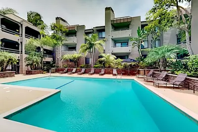 a swimming pool in front of a building at Pacific Cove Unit 111 in Los Angeles