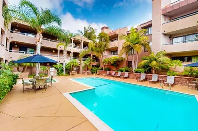 a swimming pool in front of a building at Pacific Cove Unit 111 in Los Angeles
