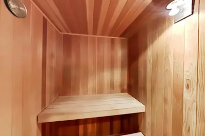 a small sauna with wooden walls and a wooden shelf at Pacific Cove Unit 111 in Los Angeles