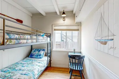 a bedroom with a bunk bed and a desk at Sailaway Cabin A in Ventura