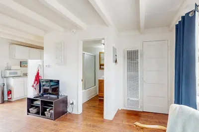 a kitchen with white walls and a kitchen with a door at Sailaway Cabin B in Ventura