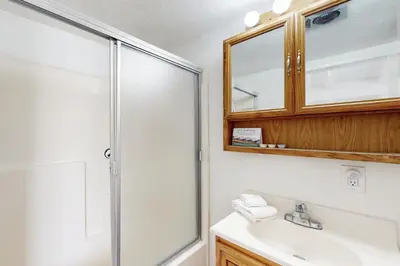 a bathroom with a shower and a sink at Sailaway Cabin in Ventura