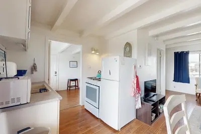 a kitchen with a white refrigerator in a room at Sailaway Cabin in Ventura