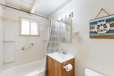 a bathroom with a sink and a toilet and a tub at Sailaway Cabin in Ventura