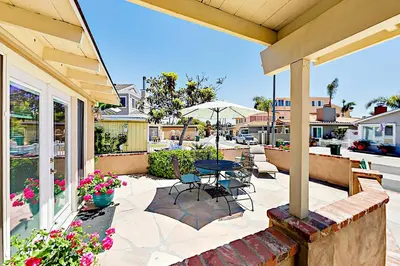 a patio with a table and chairs and an umbrella at Bangor Lane Oasis in Ventura