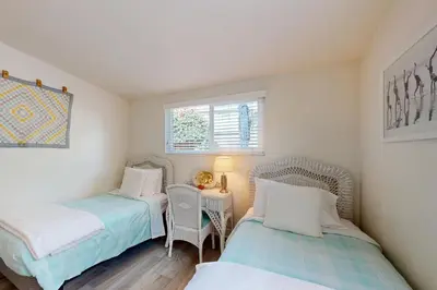 a room with two beds and a table and chairs at Bangor Lane Oasis in Ventura