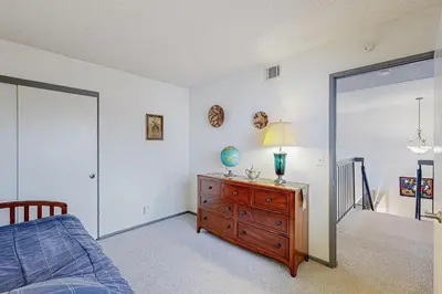 a bedroom with a bed and a dresser with a lamp at Gateshead Haven in Oxnard