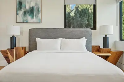 a bedroom with a white bed and two lamps at Curson Modern in Los Angeles