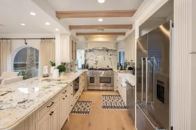 a large kitchen with marble counter tops and stainless steel appliances at Stradella Spanish in Los Angeles