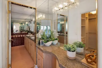 a bathroom with two sinks and a large mirror at Stradella Spanish in Los Angeles