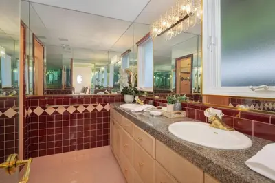 a bathroom with two sinks and a large mirror at Stradella Spanish in Los Angeles