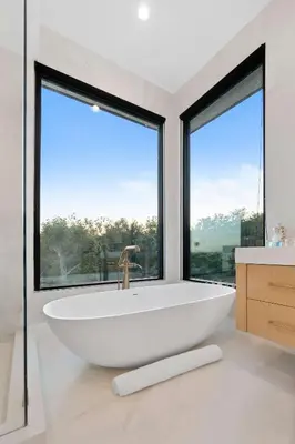 a bath tub in a bathroom with large windows at Sea Vista in Malibu