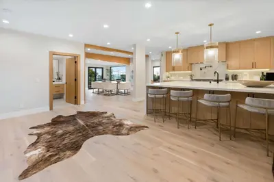 a kitchen and living room with a log on the floor at Sea Vista in Malibu