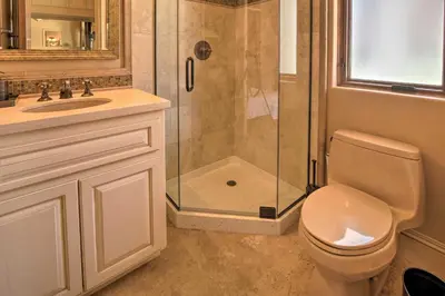 a bathroom with a shower and a toilet and a sink at Stunning Palmdale Villa Oasis on Vineyard! in Palmdale