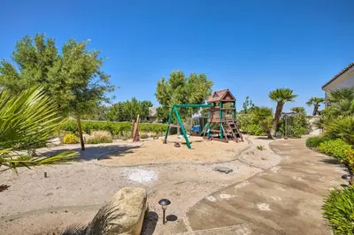 a playground with a slide and a swing at Stunning Palmdale Villa Oasis on Vineyard! in Palmdale
