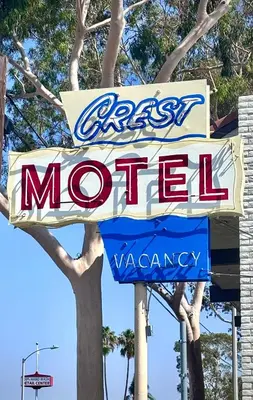 a sign for a fast food restaurant at The Crest Motel in Corona
