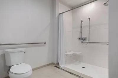 a white bathroom with a toilet and a shower at Residence Inn by Marriott Chatsworth in Chatsworth