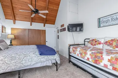 a bedroom with two beds and a ceiling fan at Serene Cabin in Lake Arrowhead