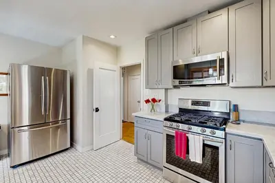 a kitchen with white cabinets and stainless steel appliances at Cedar Oasis in Ventura