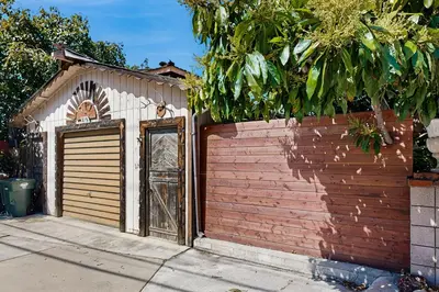a brown and white garage with a door at Cedar Oasis in Ventura