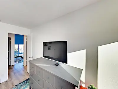 a living room with a flat screen tv on a wall at Hale I'a in Carpinteria