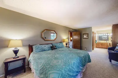 a bedroom with a large bed and a mirror at Dragon's Lair in Lake Arrowhead