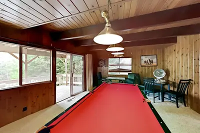 a pool room with a red pool table at Dragon's Lair in Lake Arrowhead