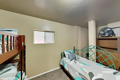 a bedroom with a bed and a clock on the wall at Dragon's Lair in Lake Arrowhead