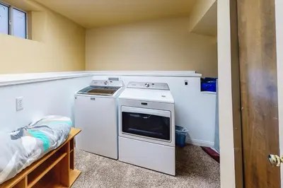 a kitchen with a stove and a washer at Dragon's Lair in Lake Arrowhead