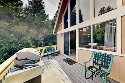 a screened in porch with a printer on the deck at Dragon's Lair in Lake Arrowhead