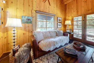 a living room with a couch and a table at Hideaway Pines in Lake Arrowhead