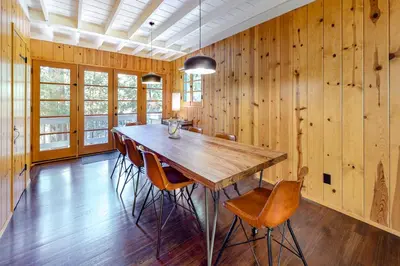 a dining room with a wooden table and chairs at Hideaway Pines in Lake Arrowhead