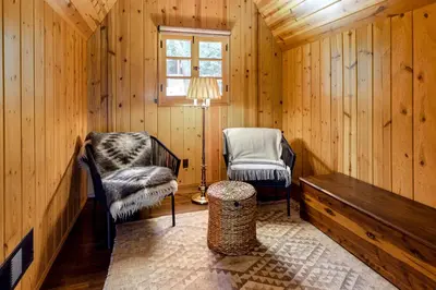 a room with two chairs and a table and a lamp at Hideaway Pines in Lake Arrowhead