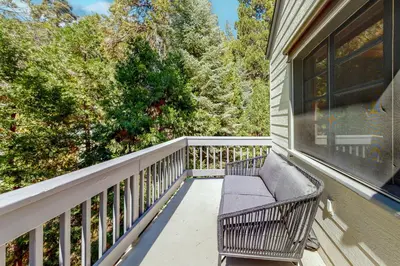 a balcony with a bench on a house at Hideaway Pines in Lake Arrowhead
