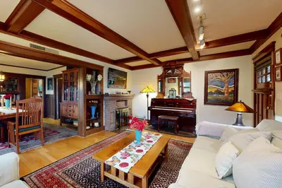 a living room with a white couch and a piano at Highland Park Haven in Los Angeles