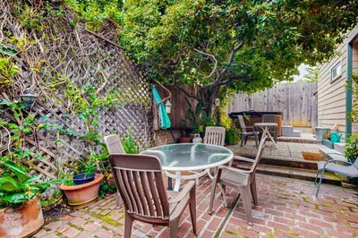 a patio with a table and chairs and a tree at Highland Park Haven in Los Angeles