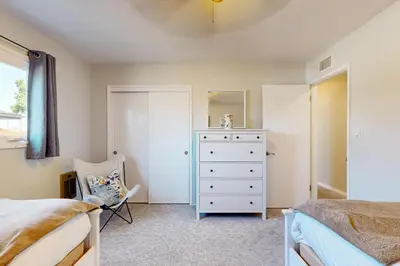 a bedroom with a bed and a dresser and a mirror at Evening Oasis in Orange
