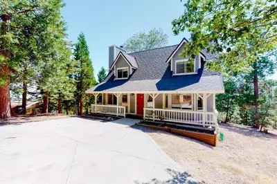 a house with a driveway in front of it at Tree-Top Getaway in Lake Arrowhead