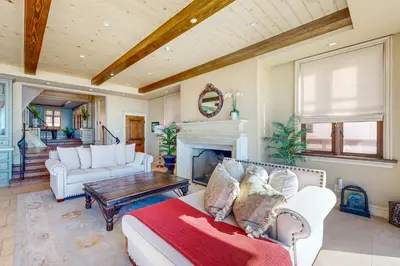 a living room with a couch and a fireplace at Breakers Way Adventure in Carpinteria