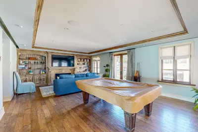 a living room with a blue couch and a table at Breakers Way Adventure in Carpinteria