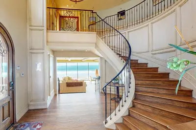 a staircase in a home with a view of the ocean at Breakers Way Adventure in Carpinteria