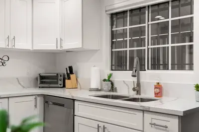 a white kitchen with a sink and a microwave at The Avalon - 35 Percent Off March! in Los Angeles