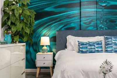 a bedroom with a bed with a painting on the wall at The Avalon - 35 Percent Off March! in Los Angeles