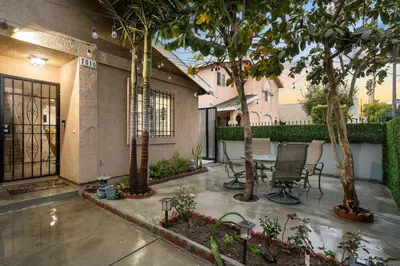 a patio with a table and chairs and trees at The Avalon - 35 Percent Off March! in Los Angeles