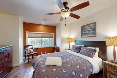 a bedroom with a bed and a ceiling fan at Brockton Diamond in Ventura