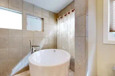 a bathroom with a white tub and a shower at Brockton Diamond in Ventura