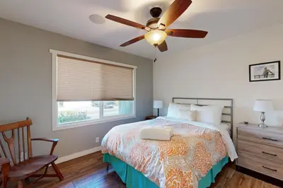 a bedroom with a bed with a ceiling fan and a window at Brockton Diamond in Ventura
