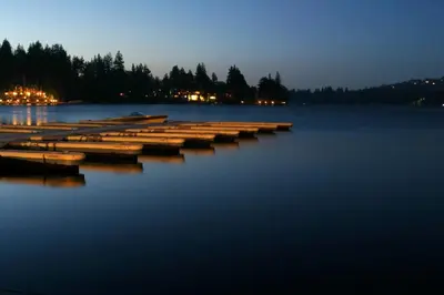 a group of boats sitting in the water at night at The Cottage in Lake Arrowhead